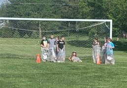BIS students participate in a sack race during field day