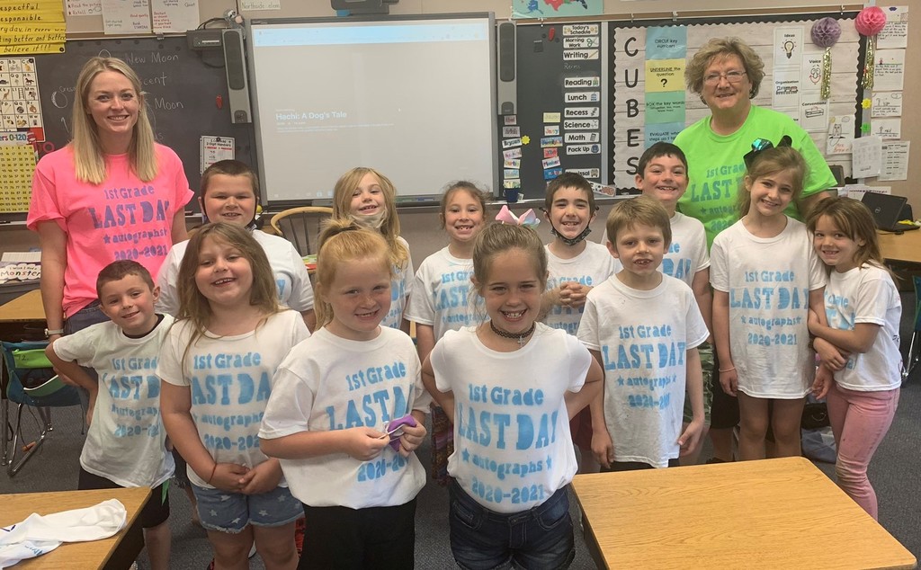 First grade students smile for the camera
