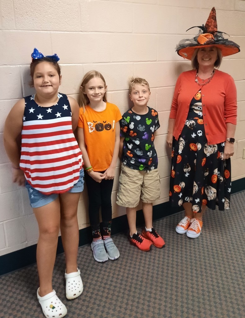 3 kids and a teacher dress up for Holiday Day
