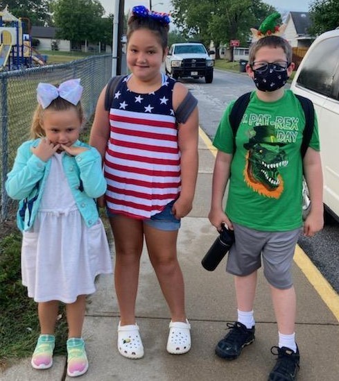 3 kids dressed like holidays