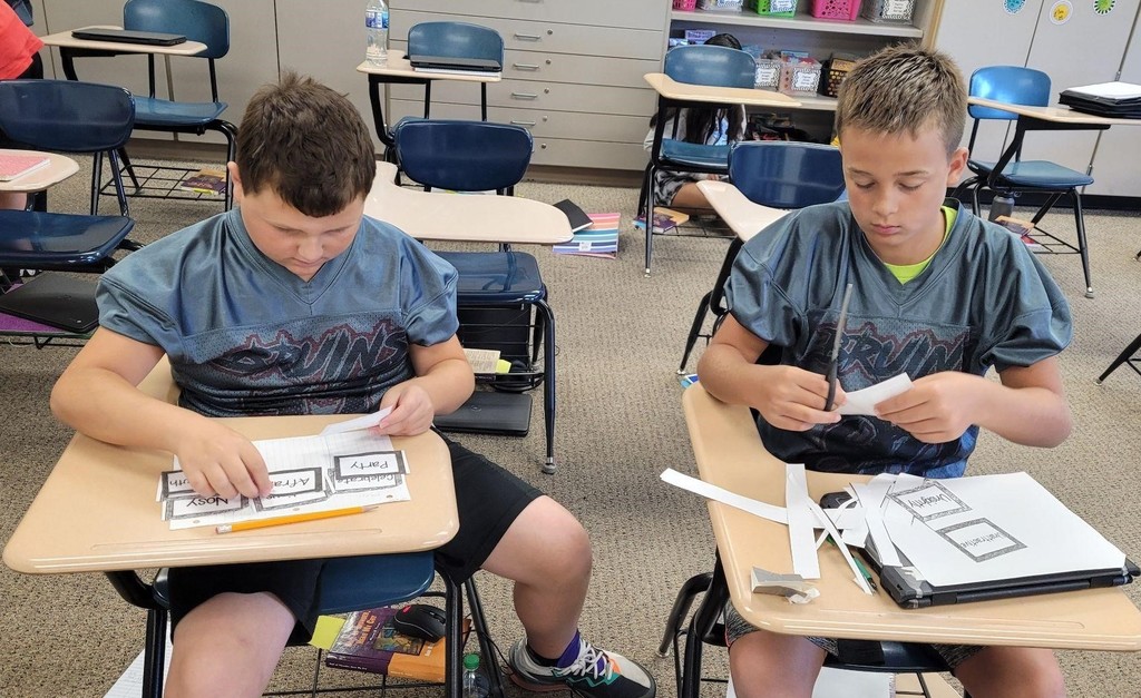2 6th grade boys work on their assignment