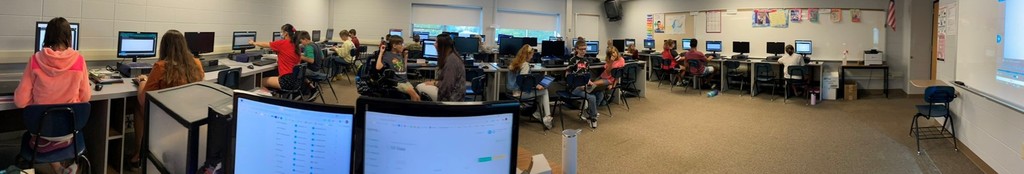 Computer students working around the room