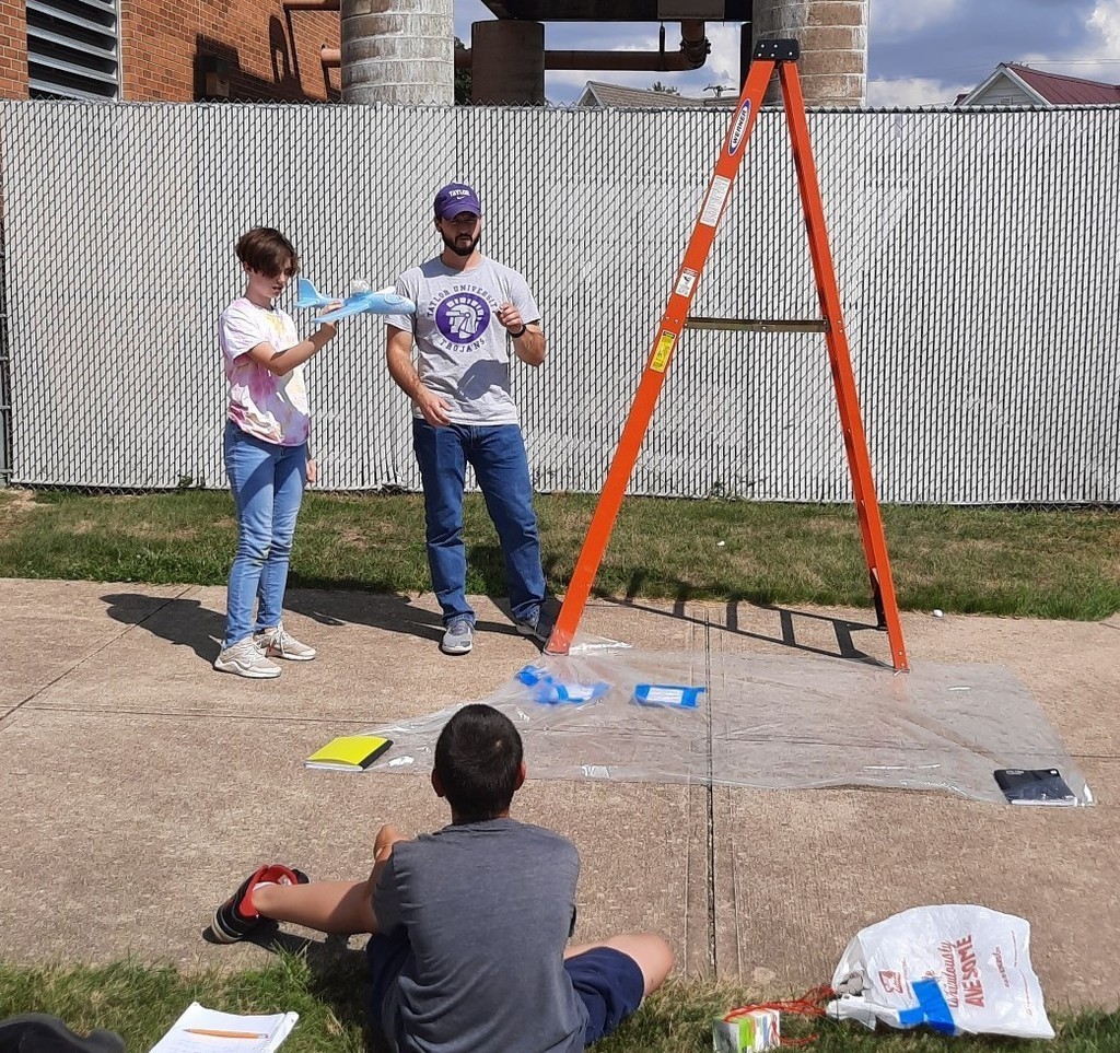Student holds up his egg plane before the egg drop