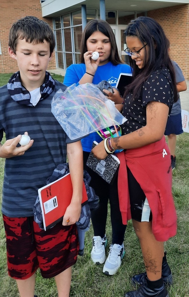 1 boy and two girls prepare their eggs for the drop