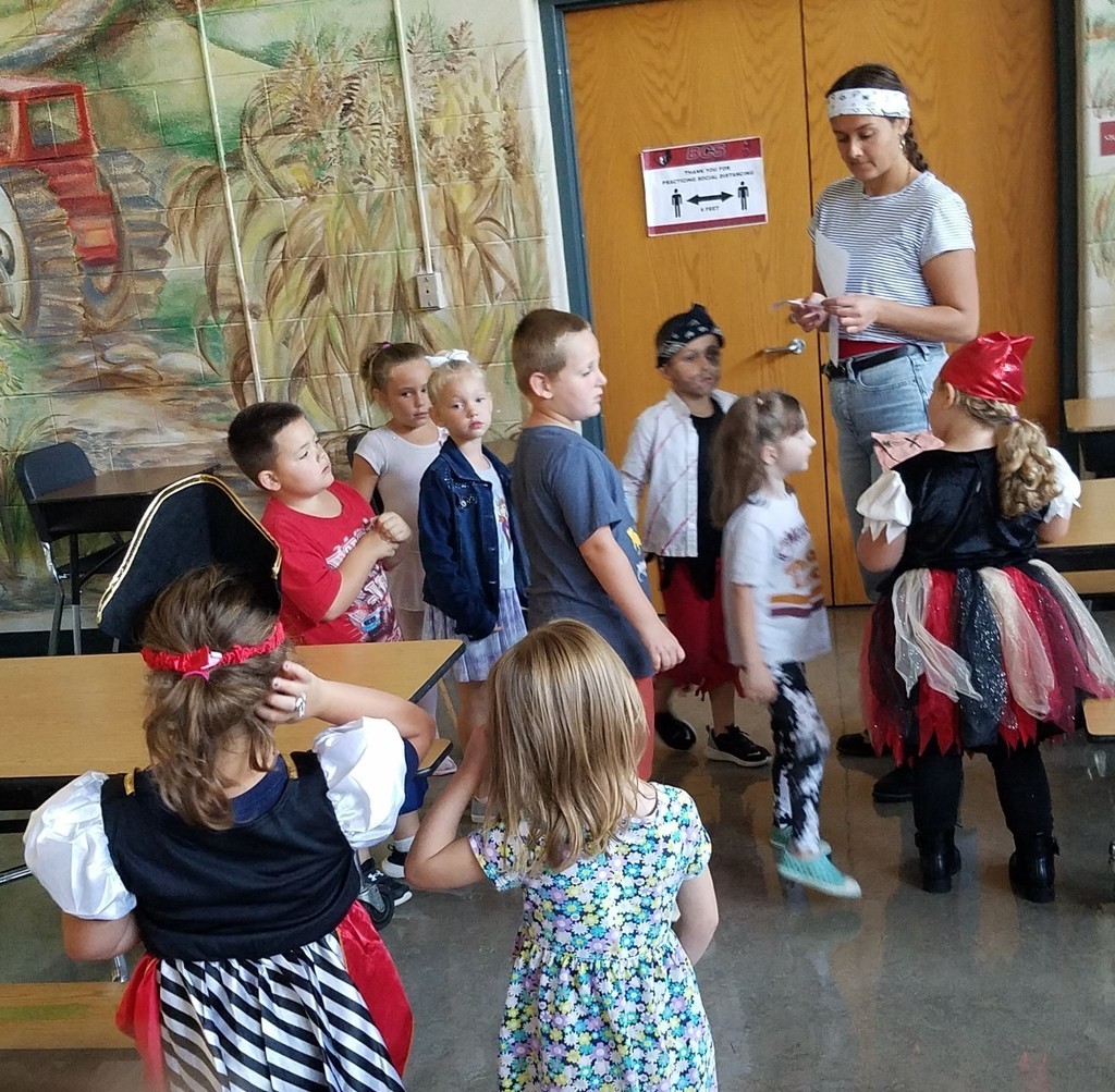 Miss Hurt leads a kindergarten treasure hunt