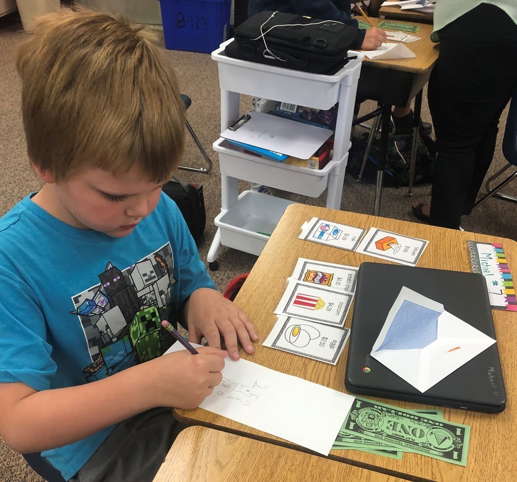 Boy working on an addition problem.