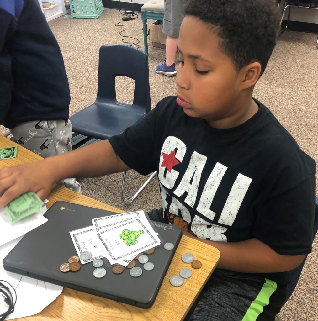 4th grade boy counts his money