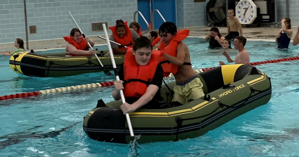 Kids rowing rafts in the BJSHS pool