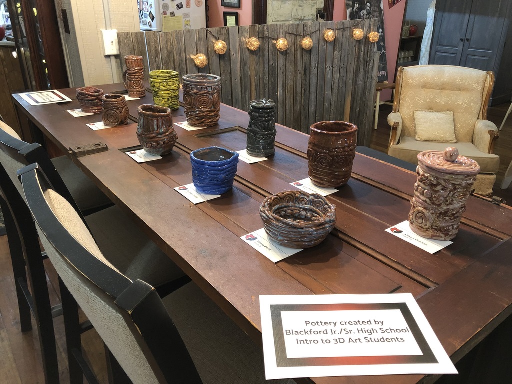 table full of pottery pieces