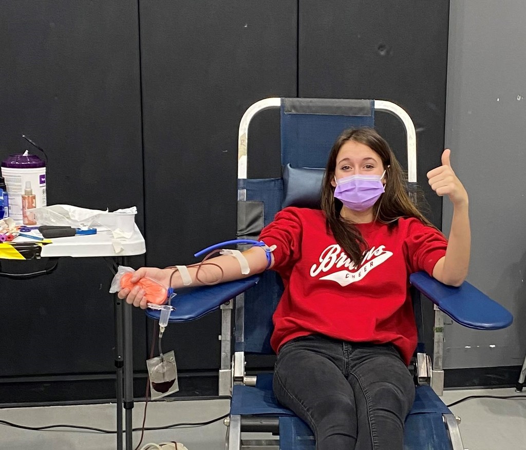 Girl giving thumbs-up during blood drive