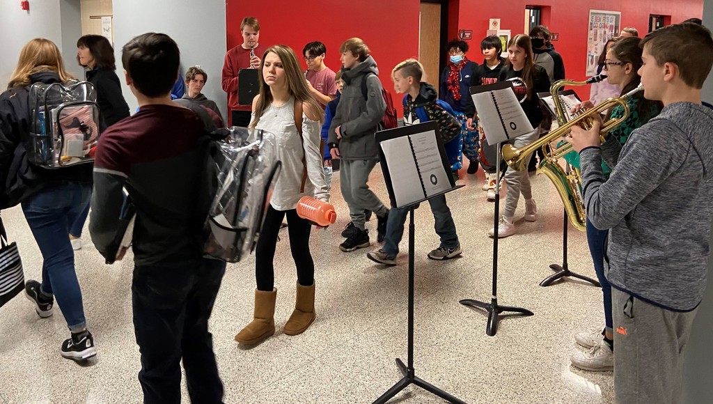 Students arrive to school serenaded by band members