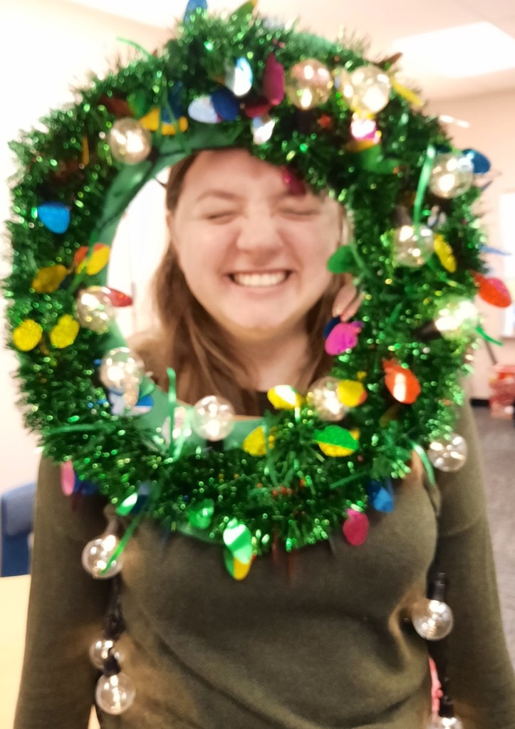 Teacher posing with eyes closed in wreath