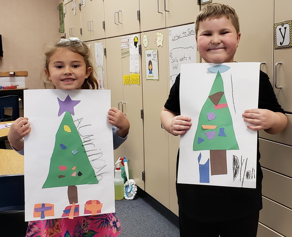 Boy and girl share their Christmas trees