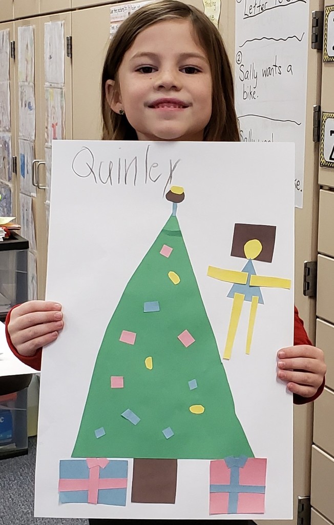 Quinley holding a Christmas tree