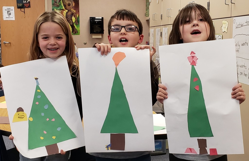 3 students hold Christmas tree photos