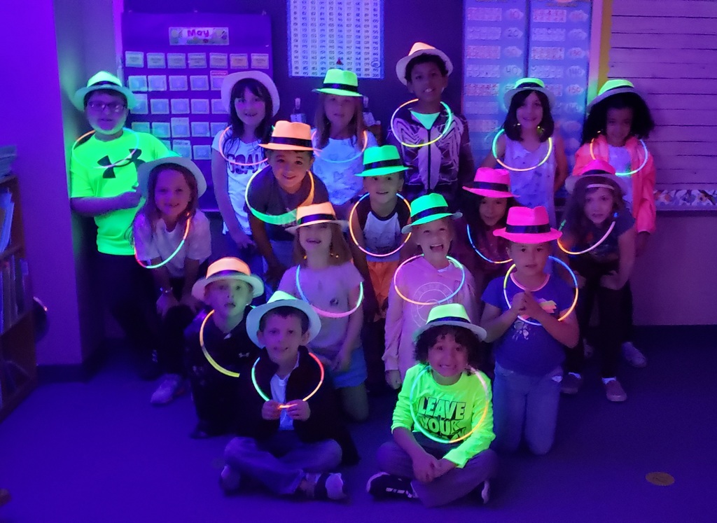 First graders pose in black light