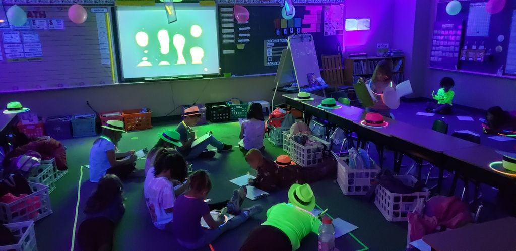 First graders do work under a black light