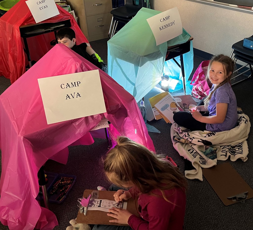 3 kids do their studies in tents