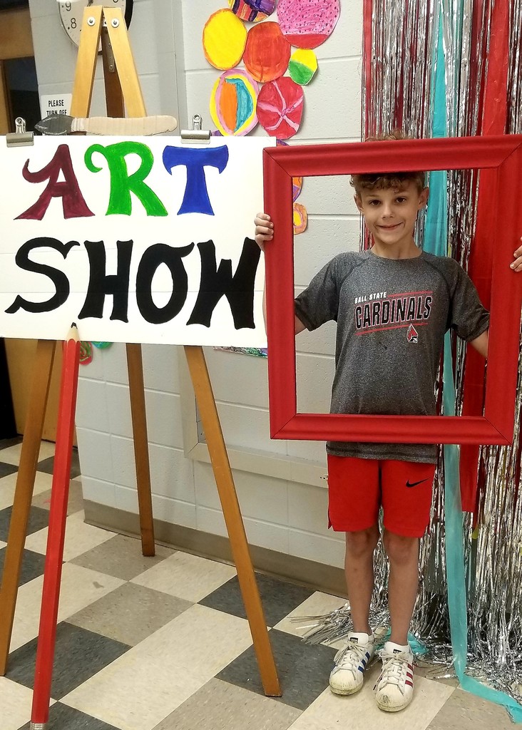 Student with art show sign