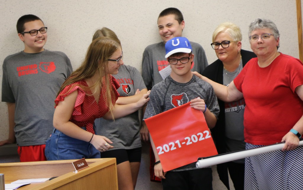 Unified sports participants share a laugh during the school board meeting