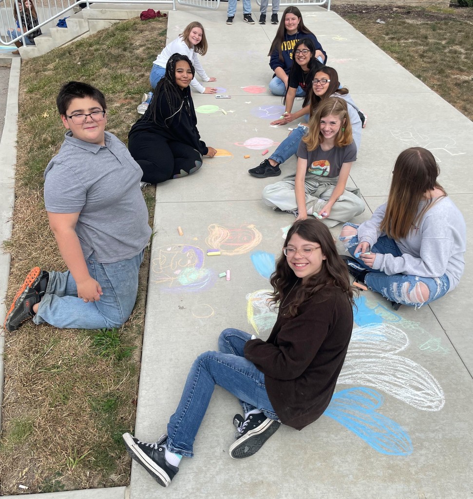 Students doing sidewalk chalk art