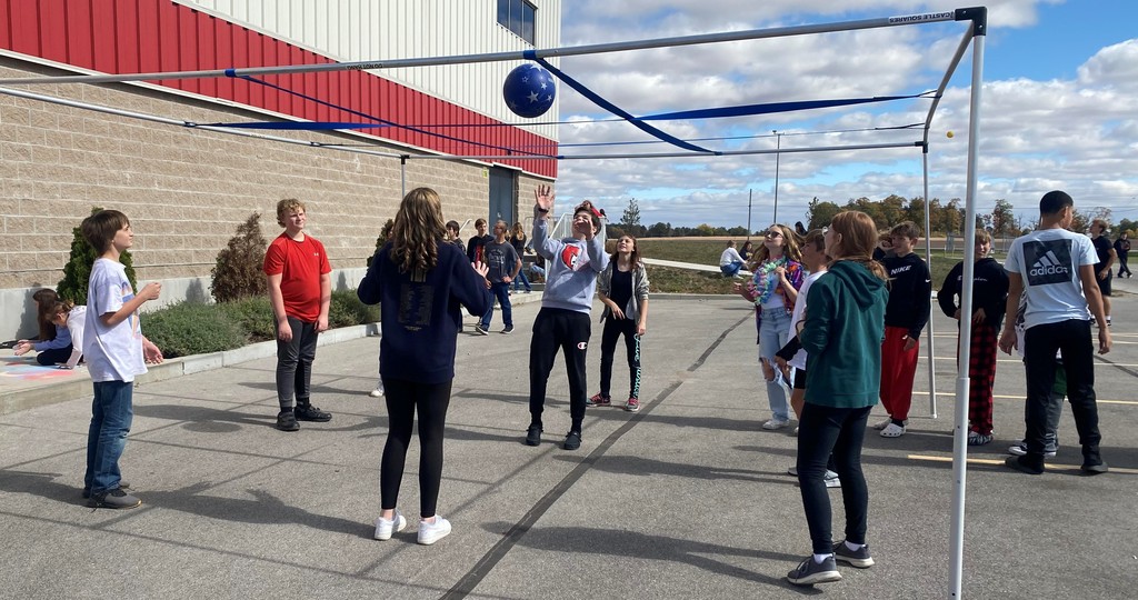 Students play volleyball during block party