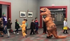 Dinosaur waves children off to class