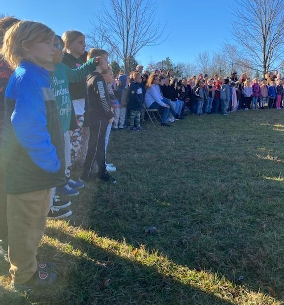 Students line up for tree planting ceremony for J. Jones