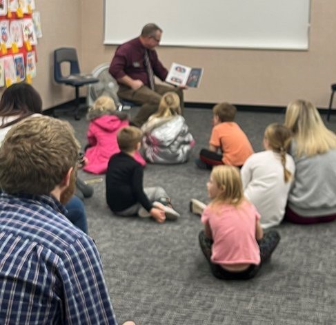 Principal Craig Campbell reads to students during Literacy Night