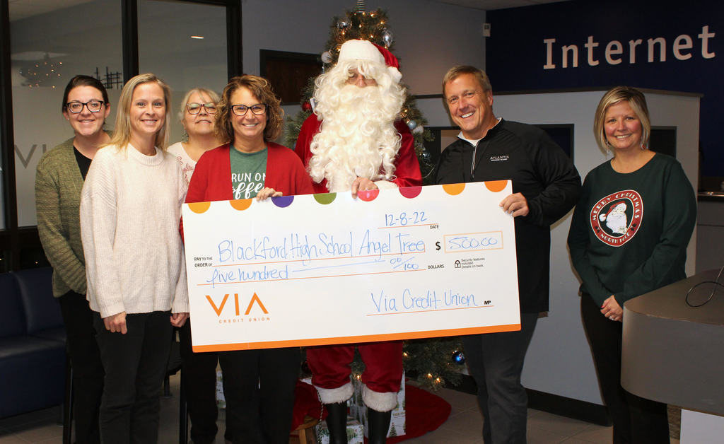 Via Credit Union and Santa present $500 to Kelli Ruble and Todd Hill for Christmas Families