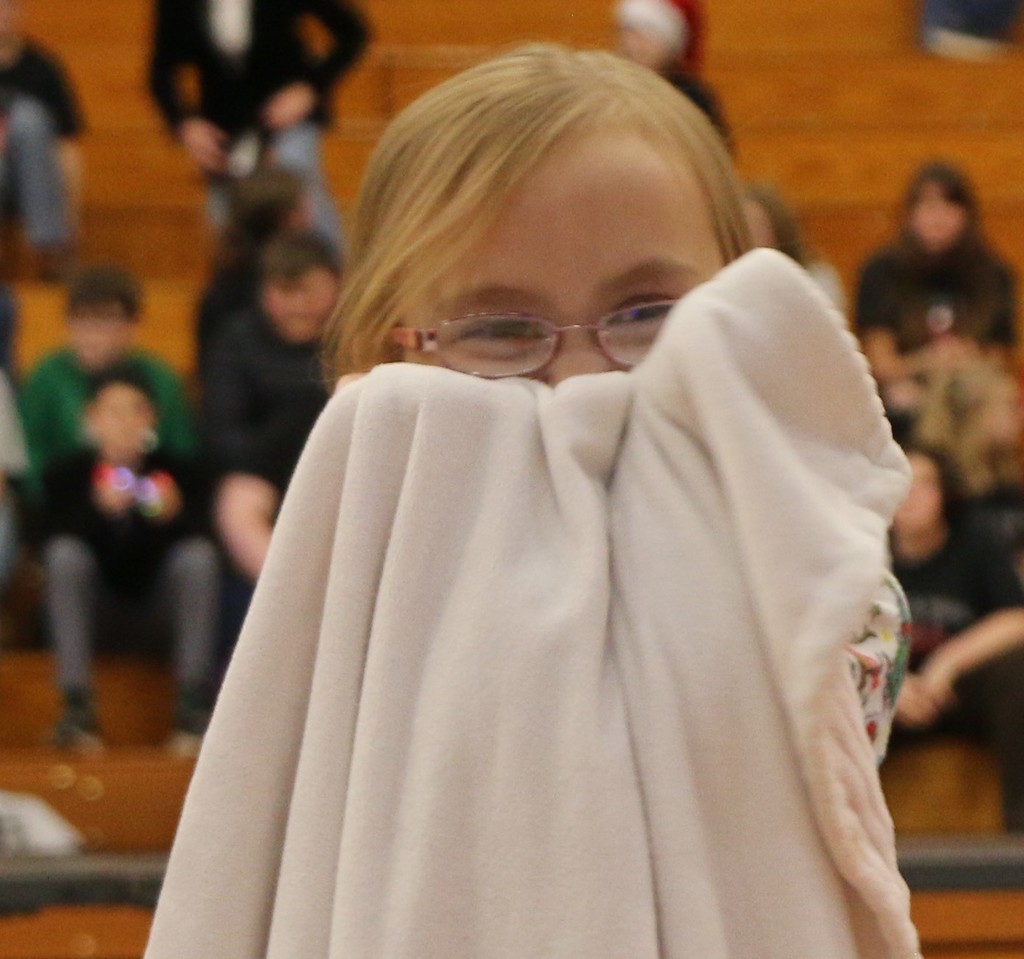 Preschooler hides behind her blanket at Christmas program
