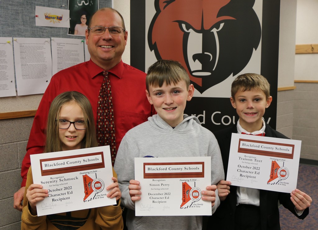 Character Ed recipients Serenity Schmuck, Simon Perry, and Traison Teer and their principal Jim Fox