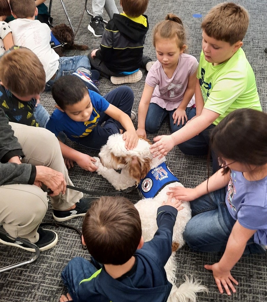 Students at BPS pet a dog