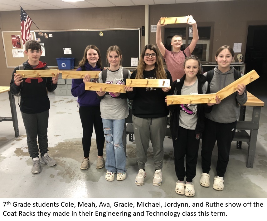 Students show off coat racks they made in Engineering and Technology class