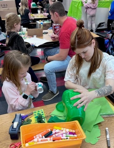 Student and her mother works on their leprechaun trap