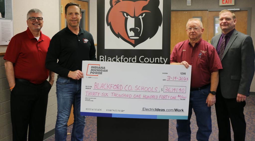 BCS accepts a rebate check from I&M for recent energy upgrades