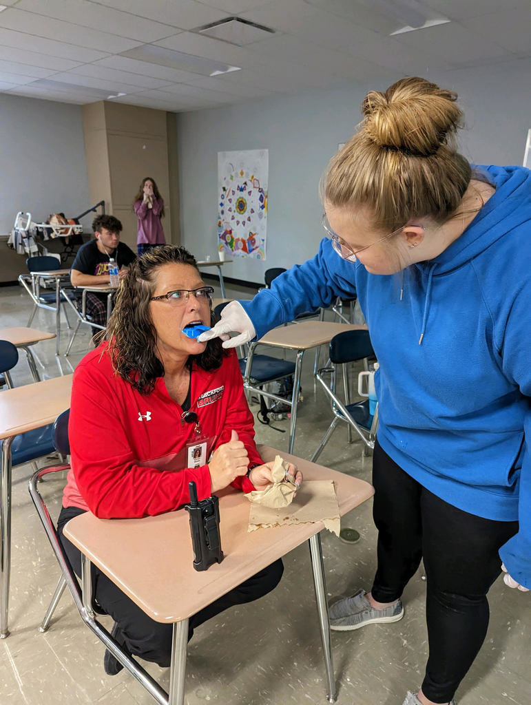 Karen Mealy participates in a dental procedure in the Health Careers class at BJSHS