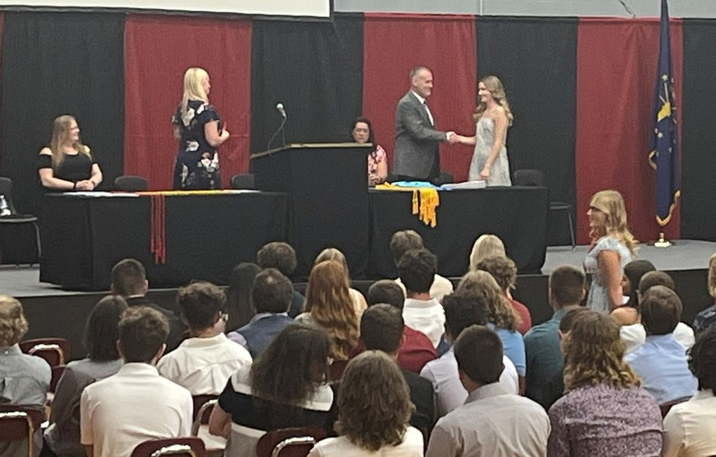 Principal Ridge congratulates Allison Jacobs