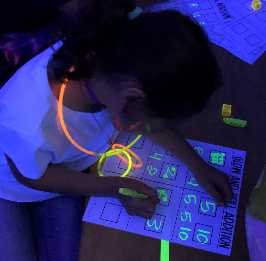 Student works on lesson during glow party