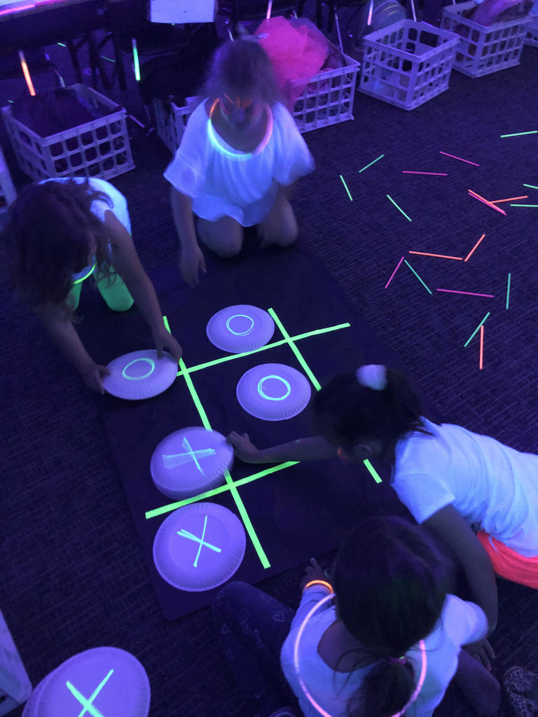1st grade students play tic tac toe during the glow party