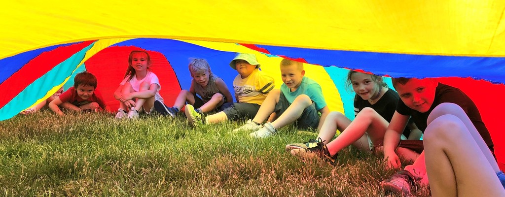 Students play under a parachute during BPS field day