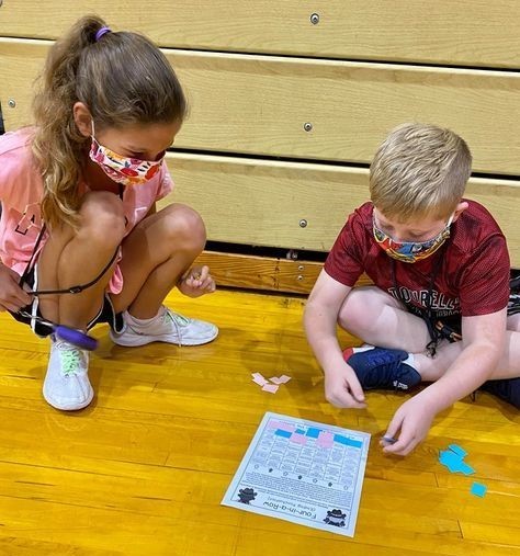Boy and girl working on lesson in gym